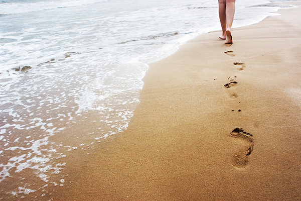 Woman walking on nassau county beach after genetic testing